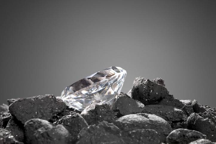 A diamond in a pile of coal shows the evolution of a precious gem.